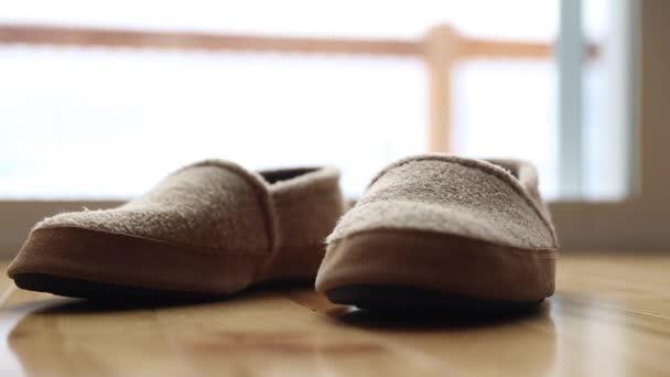 A man puts comfortable slippers - Кадри, відео