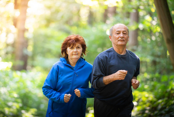 heureux couple de personnes âgées courir ensemble dans le parc
 - Photo, image