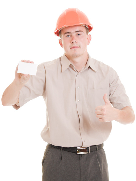 Businessman in helmet with visit card in his hand. - Foto, afbeelding