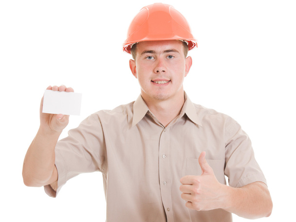 Businessman in helmet with visit card in his hand. - Zdjęcie, obraz