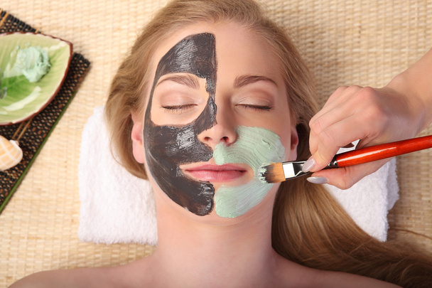 Young beautiful woman receiving facial massage and spa treatment - Photo, image