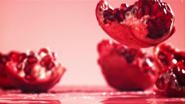 Chunks of fresh pomegranate fall on the table. Filmed on a high-speed camera at 1000 fps. High quality FullHD footage - Πλάνα, βίντεο