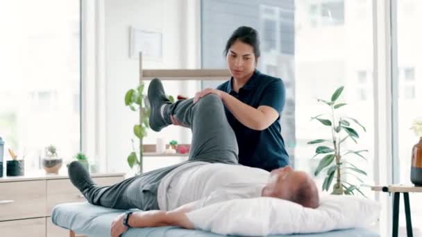 Elderly, man and physiotherapy for leg consultation for stretching muscle or rehabilitation for injury, mobility or strength. Male person, bench and healing support for knee pain, joint or exercise. - Footage, Video