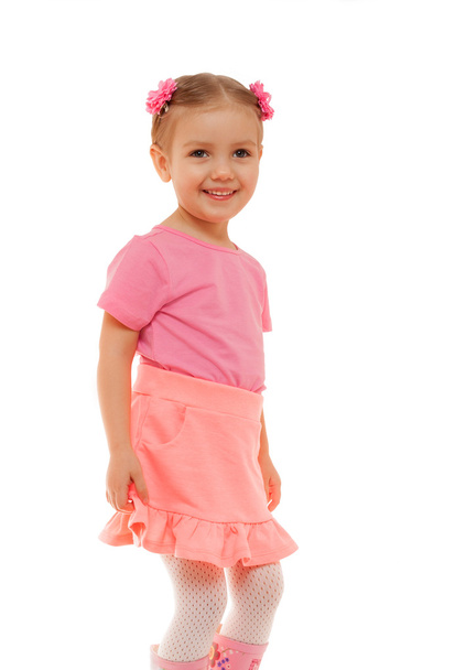 Child girl pink t-shirt skirt fun smiling face studio portrait isolated white - Фото, изображение