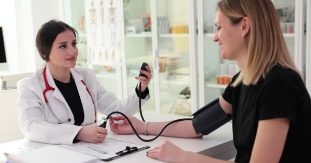 Il terapeuta misura la pressione sanguigna del paziente sul tonometro in clinica. Controllo della pressione sanguigna nelle donne in gravidanza - Filmati, video