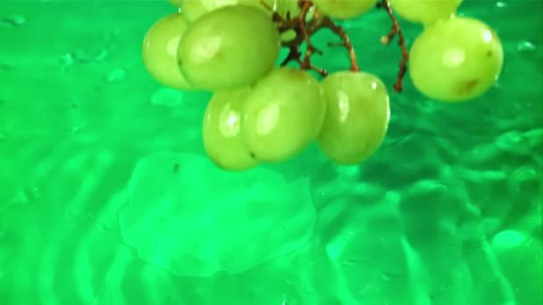 Green grapes fall with splashes into the water. Top view. Filmed on a high-speed camera at 1000 fps. High quality FullHD footage - Кадры, видео