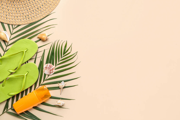 Composition with beach accessories and palm leaves on beige background - Photo, Image