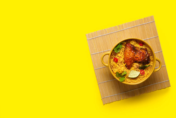Ciotola di pollo biryani tradizionale su sfondo giallo - Foto, immagini