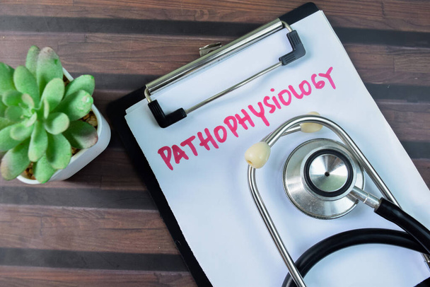 Concept of Pathophysiology write on paperwork isolated on wooden background. - Photo, Image