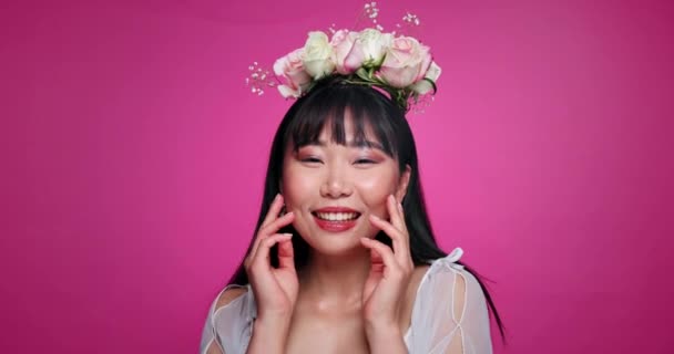 健康,自信,スキンケアのための花冠を持つ幸せな女性のピンクの背景,美しさと顔. サロン,花の美しさとアジア人の肖像画 自然な化粧品とスタジオで光る. - 映像、動画