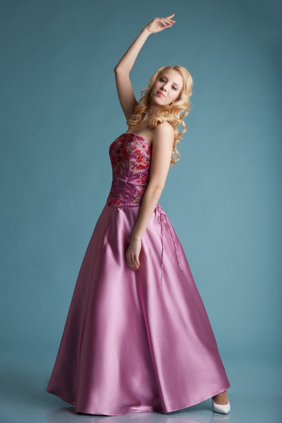 Pretty blonde girl posing in dress for prom - Foto, immagini