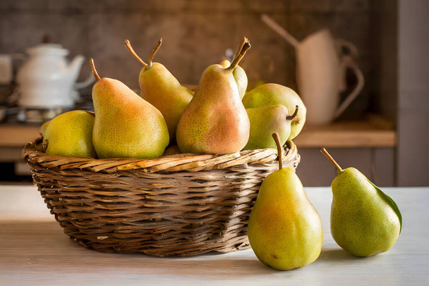 Fresh Organic Pears in a Rustic Basket on a Kitchen Counter - Photo, Image