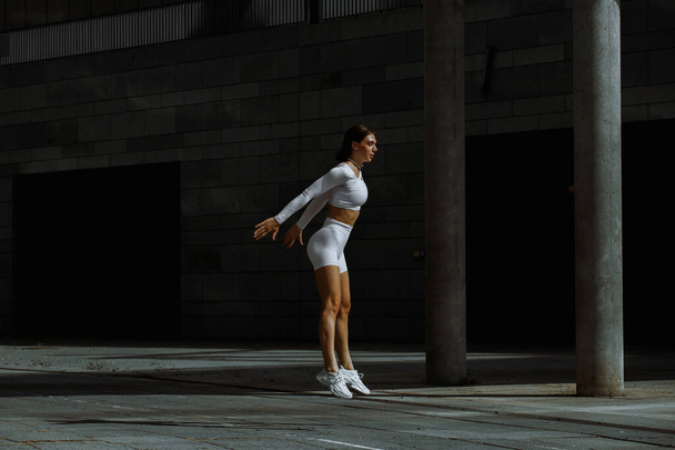 Sportovní dívka vystupující s funkčním tréninkem na ulici. - Fotografie, Obrázek