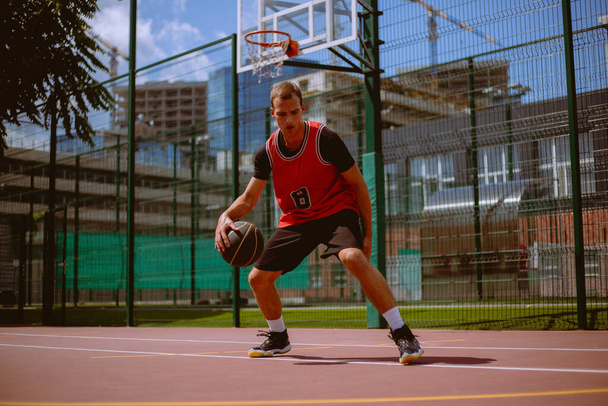 Muž basketbalista hraje streetball během horkého dne - Fotografie, Obrázek