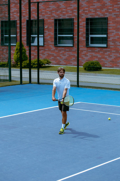 Tennis player training on a professional tennis court - Photo, Image