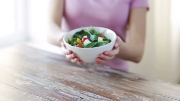 close up of young woman hands showing salad bowl - Materiaali, video