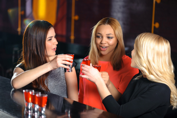 Three women have a drink in the bar - Zdjęcie, obraz