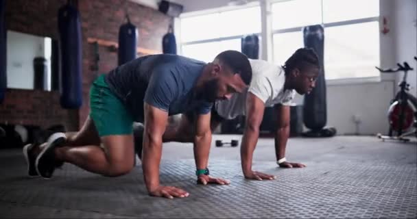 Man, fitness and mountain climber exercise at gym for workout, cardio or indoor training together. Young active male person or friends in teamwork for sports, core strength or power at health club. - Footage, Video