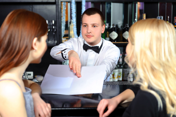 Women and barman by the counter - Photo, image