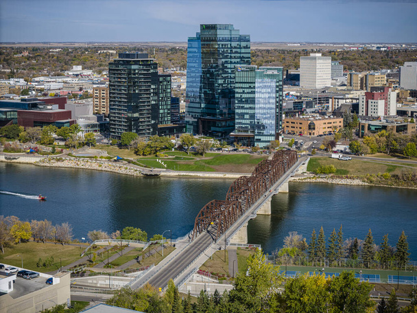 A drones perspective of the energetic and vibrant Downtown Saskatoon during the summer season, where the city comes alive with bustling streets, gleaming skyscrapers and the joyous hum of urban life. - Photo, Image