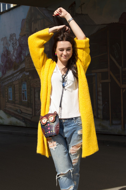 Young girl in a yellow coat - Fotó, kép