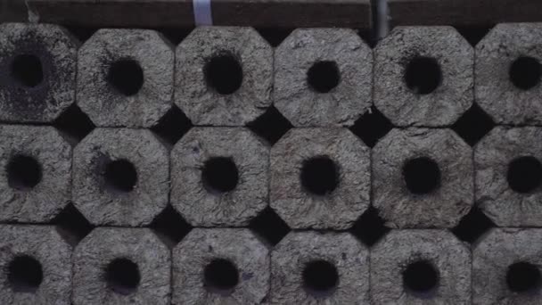 Fuel briquettes. Production of fuel from pressed sawdust. Briquettes stacked on pallets. - Footage, Video