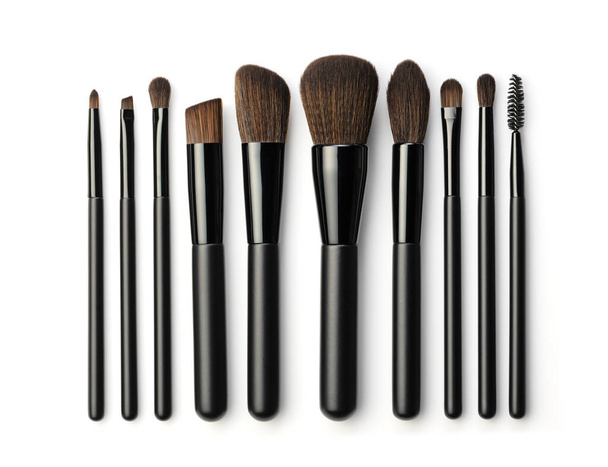 Set of black makeup brushes isolated on white background. Top view. - Photo, Image