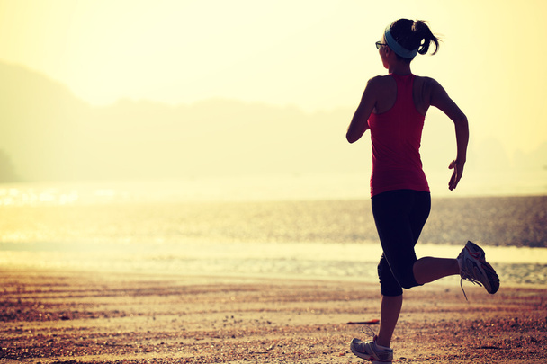 Atleta feminina correndo à beira-mar
 - Foto, Imagem