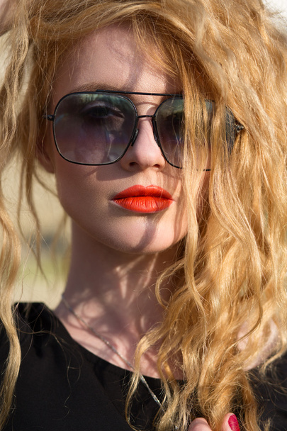 beautiful fashion model with red hair wearing glasses - 写真・画像