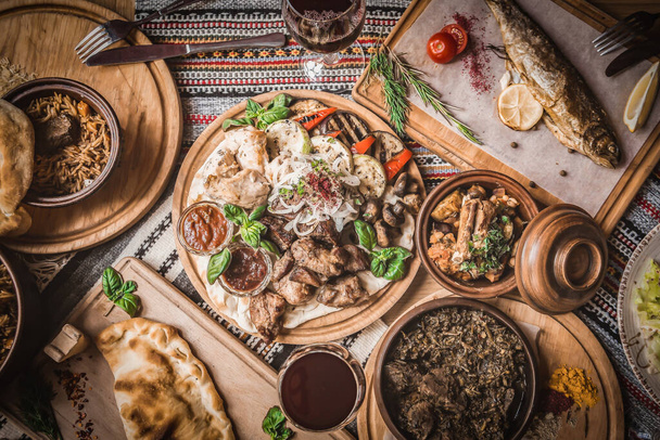 Arabic Cuisine: Middle Eastern traditional lunch. It's also Ramadan "Iftar". The meal eaten by Muslims after sunset during Ramadan. Assorted of Arabic oriental dishes. top view with close up. - Photo, Image