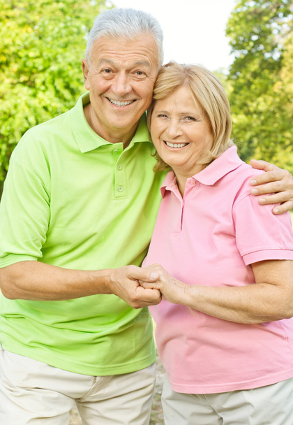 Happy senior couple holding hands outdoors - Photo, Image