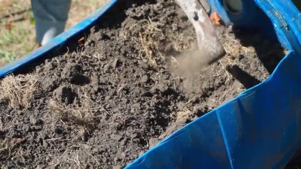 Mini garden bed in an old plastic barrel. Plowing the soil in a mini garden bed. High quality FullHD footage - Footage, Video