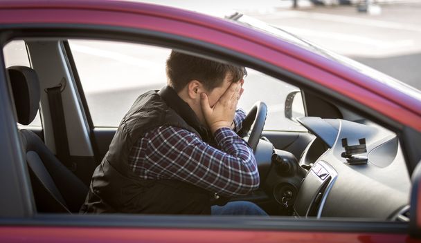portrait of shocked male driver closing face with hands - Фото, изображение
