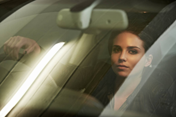 Woman, driver and look through windshield, portrait and car for transportation and night commute. Female, travel and vehicle pose for business, action and actress shot for commercial or movie scene. - Photo, Image