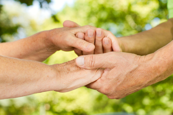 Closeup of senior hands holding together - Photo, Image