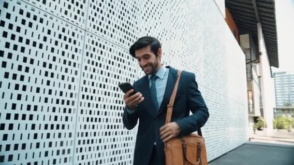 Businessman talking to manager by using phone and dancing with joyful. Investor receive a good news, getting promotion, getting a successful job from phone while express feeling of overjoy. Exultant. - Footage, Video