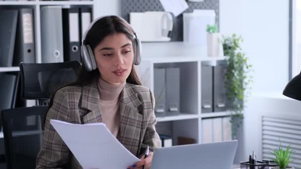 Happy caucasian businesswoman talking on work video call or meeting using laptop, managing financial papers in office. Online briefing, internet conversation. - Footage, Video