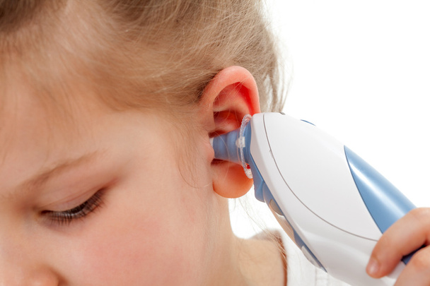 Taking temperature with ear thermometer - 写真・画像