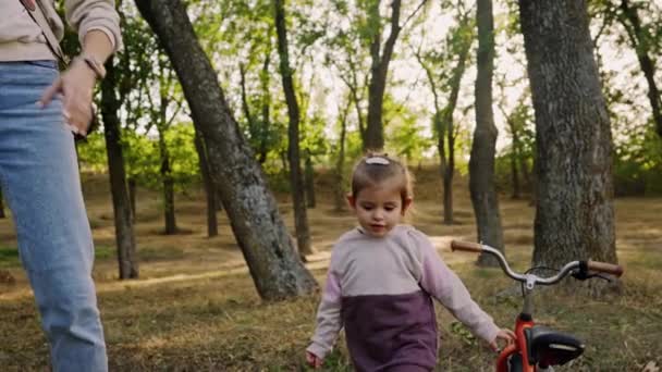 Playful emotional kid walking with her mom in autumn park or forest. Spend time together - Footage, Video