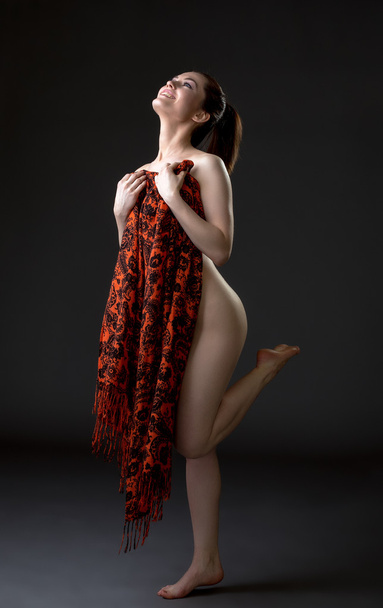 Cheerful nude woman covers her body with cloth - Фото, зображення