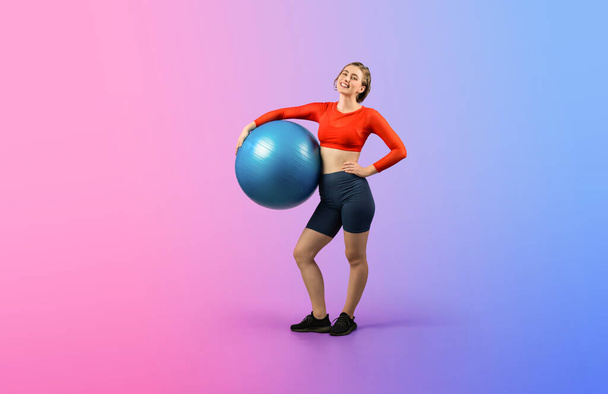 Full body length gaiety shot athletic and sporty young woman with fitness exercising ball in standing posture on isolated background. Healthy active and body care lifestyle. - Valokuva, kuva
