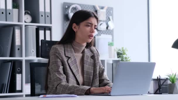 Teleurgesteld blanke vrouw werknemer facepalming tijdens het werk met laptop in het kantoor. Ontevreden per ongeluk, mislukking, problemen of problemen. - Video