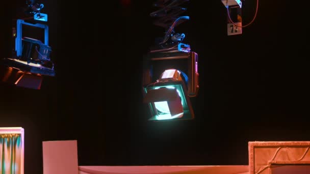 Netwerk van professionele verlichtingsarmaturen opgehangen in een donkere televisiestudio - Video