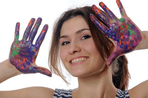 女の子は、カラフルなペイントで描かれた彼女の手を示しています。  - 写真・画像