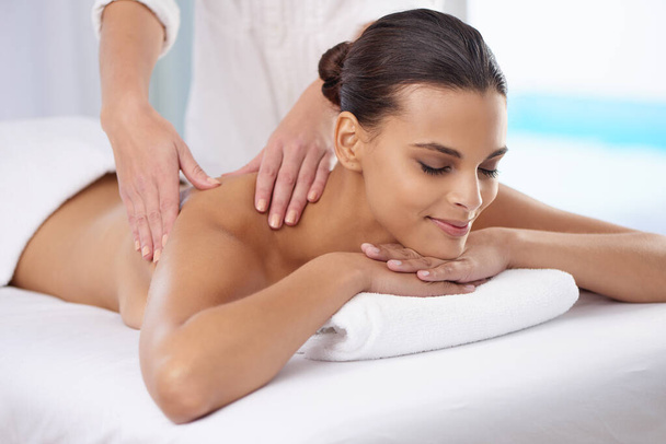 Spa, massage and wellness of a woman, vacation or weekend break with health therapy for stress relief. Hands for body care, relaxing or skin session of a customer feeling calm or happiness with peace. - Photo, Image