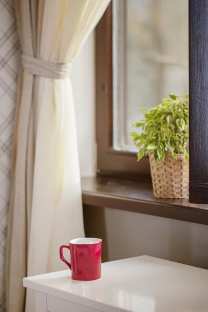 Cup for coffee against a window - Фото, изображение