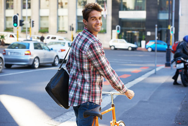 Portrait, happy man and travel on bicycle in city on eco friendly transport outdoor, commute and walking. Cycling, person and bike in urban town, road and street for journey on sidewalk in Canada. - Photo, Image