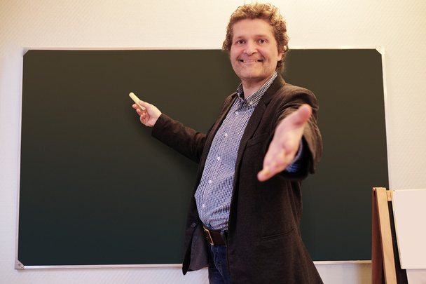 Male teacher writes on blackboard - Fotografie, Obrázek
