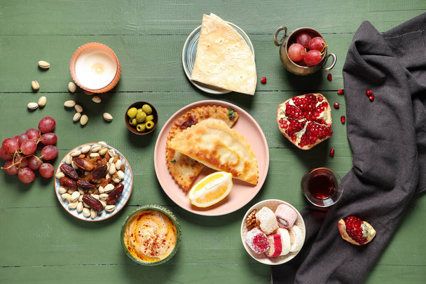 Παραδοσιακά ανατολίτικα πιάτα και τουρκικό τσάι σε πράσινο ξύλινο τραπέζι. Γιορτάζουμε το Ραμαζάνι - Φωτογραφία, εικόνα