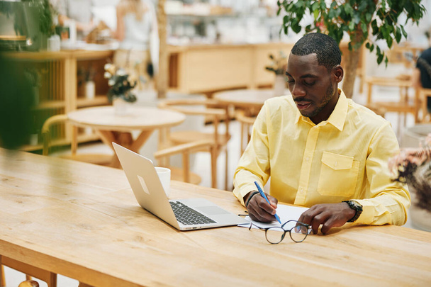 Mies yrittäjä henkilö verkossa liikemies työ kannettava tietokone moderni mies istuu opiskelija tietokone työpaikalla ammatillinen nuori toimisto käyttäen kaveri teknologia viestintä koulutus - Valokuva, kuva